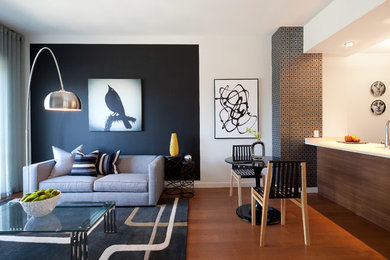 Trendy open concept medium tone wood floor living room photo in New York