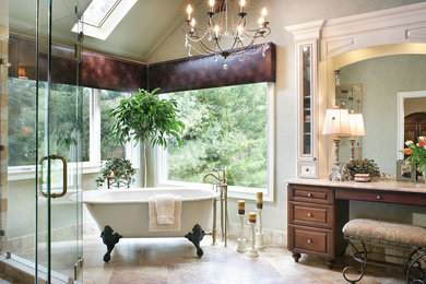 Elegant master stone tile and beige tile travertine floor bathroom photo in New York with an undermount sink, raised-panel cabinets, medium tone wood cabinets and marble countertops
