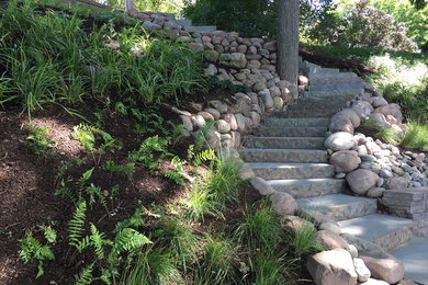 Inspiration for a mid-sized traditional partial sun hillside stone landscaping in Philadelphia.