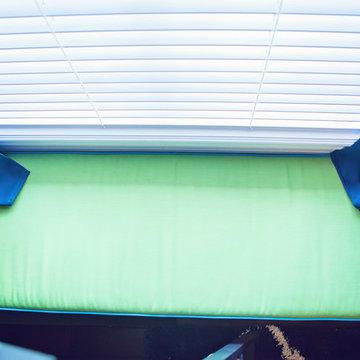 Bright cushion done in Sunbrella Canvas Parrot adds splash of fun to child's roo
