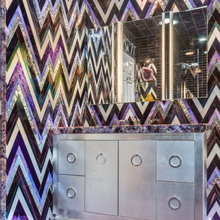 Mid-sized eclectic kids' multicolored tile and glass sheet purple floor bathroom photo in New York with recessed-panel cabinets, gray cabinets, multicolored walls, a drop-in sink, quartzite countertops and a hinged shower door