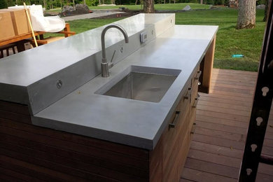 Inspiration for a mid-sized contemporary backyard patio kitchen remodel in Toronto with decking and a roof extension