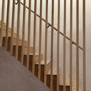 Modelo de escalera en U, actual, de tamaño medio, con escalones de madera, contrahuellas de madera y barandilla de madera