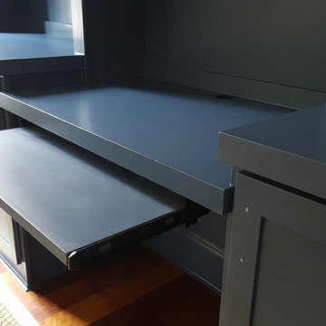 Dark Blue Office Built-in With Center Desk and Pullouts