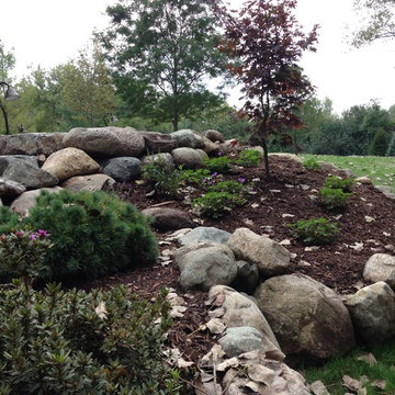 Extended patio with boulder wall