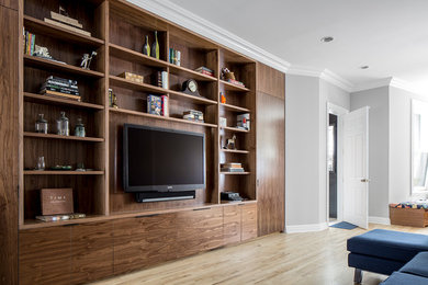 Photo of a mid-sized transitional open concept living room in New York with grey walls, light hardwood floors and a built-in media wall.