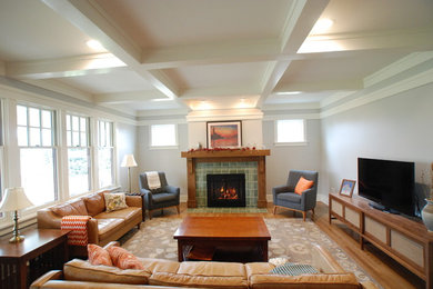 Large mid-century modern medium tone wood floor and brown floor living room photo in Other with a tile fireplace, gray walls, a standard fireplace and a tv stand