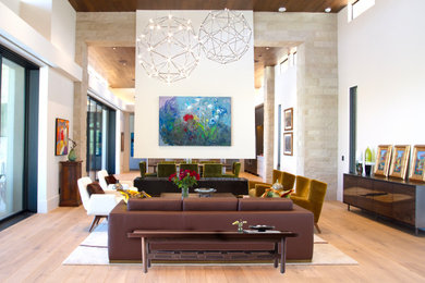Example of a large minimalist open concept light wood floor and wood ceiling living room design in Phoenix with a metal fireplace
