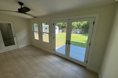 This is an example of a transitional back porch design in Orlando.