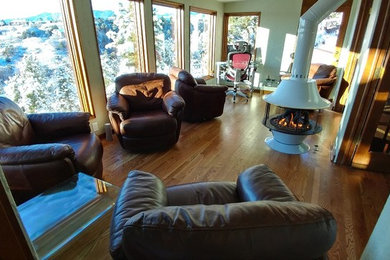 Example of a small transitional enclosed medium tone wood floor living room design in Denver with no tv