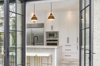 Kitchen - transitional multicolored floor kitchen idea in Toronto with shaker cabinets, white cabinets, white backsplash, stone slab backsplash, stainless steel appliances, an island and white countertops
