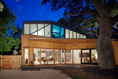 Inspiration for a contemporary two-storey exterior in Austin with wood siding.