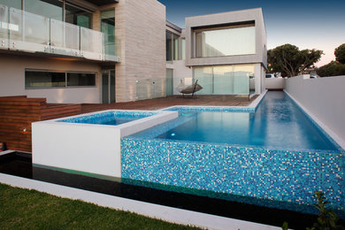 Photo of a large contemporary side yard custom-shaped aboveground pool in Perth with a water feature.
