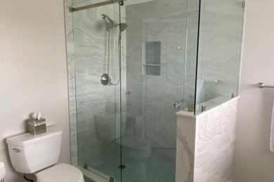 Mid-sized beach style master beige tile and porcelain tile porcelain tile, beige floor and single-sink bathroom photo in Boston with flat-panel cabinets, white cabinets, a two-piece toilet, beige walls, an undermount sink, quartz countertops, white countertops and a built-in vanity