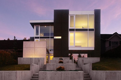 Example of a trendy black three-story mixed siding exterior home design in Calgary