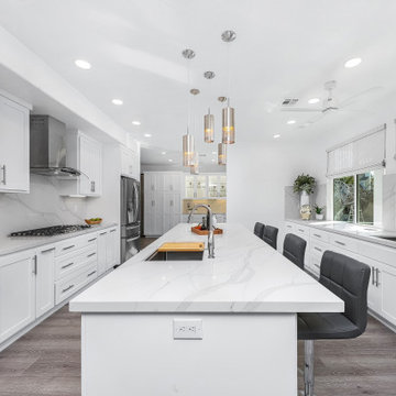Custom White Shaker Cabinetry Kitchen with Veined Quartz Countertops and Full Sp