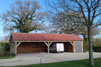 Example of an arts and crafts garage design in Devon