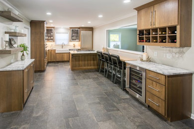 Inspiration for a modern galley gray floor enclosed kitchen remodel in Other with a farmhouse sink, flat-panel cabinets, brown cabinets, stainless steel appliances and gray countertops