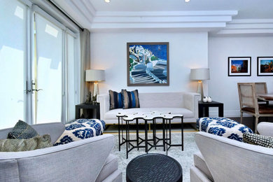 Mid-sized tuscan formal and open concept medium tone wood floor, brown floor and tray ceiling living room photo in Los Angeles with white walls, a standard fireplace, a tile fireplace and no tv