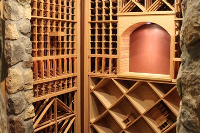 Inspiration for a mid-sized timeless concrete floor wine cellar remodel in Denver