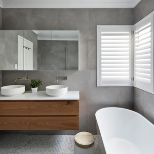 Design ideas for a contemporary master bathroom in Perth with flat-panel cabinets, medium wood cabinets, a freestanding tub, an alcove shower, gray tile, grey walls, mosaic tile floors, a vessel sink, engineered quartz benchtops, grey floor, an open shower, white benchtops, a double vanity and a floating vanity.