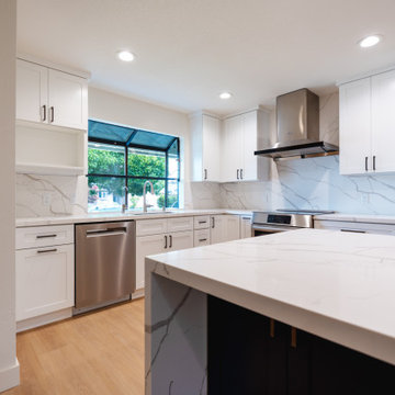 Modern White Shaker Kitchen with Navy Blue Island and Waterfall Quartz Counterto