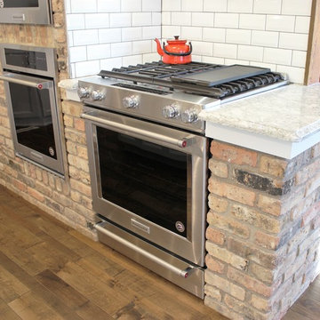 Atkinson, IL- Ranch Home Remodel With Bright White Cabinets and Brick Wall