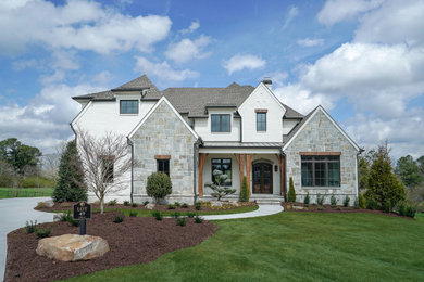 French country white two-story brick house exterior photo in Atlanta with a hip roof and a shingle roof