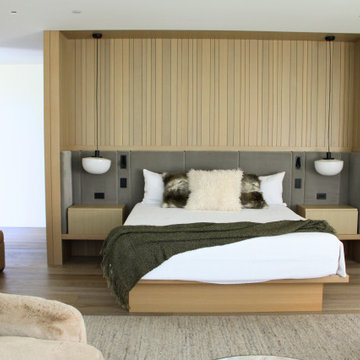 Custom Integrated Bed Wall with Concealed Closet Millwork