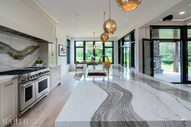 Inspiration for a large modern single-wall light wood floor and beige floor eat-in kitchen remodel in Philadelphia with a drop-in sink, recessed-panel cabinets, white cabinets, quartz countertops, multicolored backsplash, quartz backsplash, stainless steel appliances, an island and white countertops