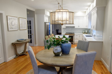 Example of a mid-sized beach style medium tone wood floor and brown floor kitchen/dining room combo design in Boston