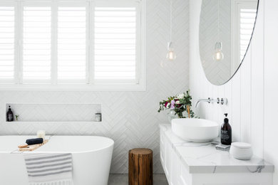 This is an example of a country bathroom in Sydney with shaker cabinets, white cabinets, a freestanding tub, an open shower, white tile, engineered quartz benchtops, an open shower, a single vanity and panelled walls.