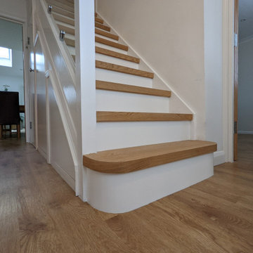 Engineered oak stair cladding with modern white painted risers, Epping Forest
