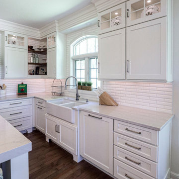 White Kitchen with Gray Quartz Countertops, Farmhouse Sink and Hardwood Floors