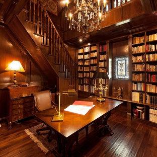Inspiration for a mediterranean home office and library in Other with brown walls, dark hardwood flooring, a freestanding desk and brown floors.