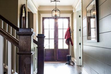 This is an example of a large country entry hall in Nashville with beige walls, dark hardwood floors, a double front door and a glass front door.