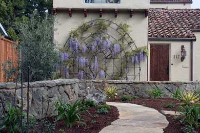 Inspiration for a large mediterranean side yard formal garden in San Francisco with a garden path and natural stone pavers.