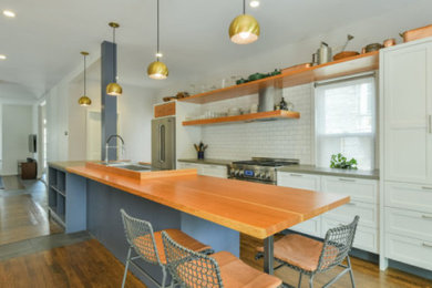 Eat-in kitchen - large contemporary galley dark wood floor eat-in kitchen idea in Boston with an integrated sink, open cabinets, medium tone wood cabinets, concrete countertops, white backsplash, ceramic backsplash, stainless steel appliances, an island and gray countertops