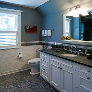 Secondary Bath with White Subway Tile Wainscot and Mosaic Floor