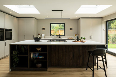 Design ideas for a modern kitchen in Hertfordshire with flat-panel cabinets and white worktops.