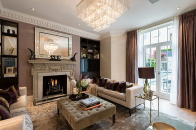 Inspiration for a large transitional enclosed light wood floor family room remodel in London with a standard fireplace, a stone fireplace and a wall-mounted tv