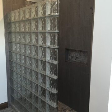 Straight glass block shower wall with large format ceramic tiles