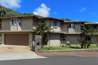 Example of a large classic beige two-story house exterior design in Hawaii with a hip roof and a shingle roof