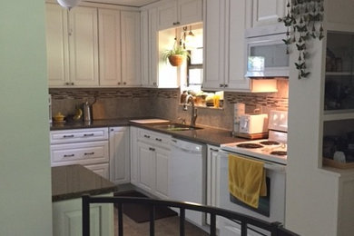 Inspiration for a small transitional galley enclosed kitchen remodel in Other with recessed-panel cabinets