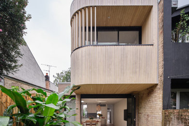 Inspiration for a small contemporary two-storey brown exterior in Sydney with wood siding.