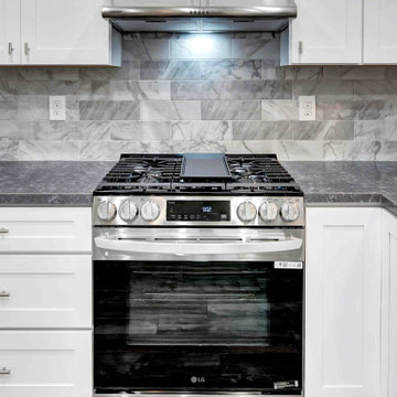 Culinary Centerpiece: Gas Range Framed by Marble Backsplash