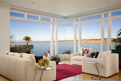 Living room - contemporary open concept medium tone wood floor living room idea in San Diego with white walls
