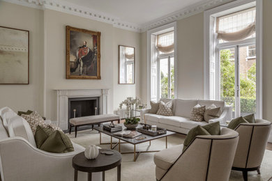 This is an example of a large traditional formal open plan living room in London with beige walls, medium hardwood flooring, a standard fireplace, a stone fireplace surround, brown floors and a chimney breast.