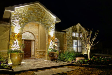 Entryway - large traditional entryway idea in Houston with a brown front door