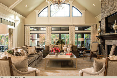 Living room - large transitional open concept dark wood floor and beige floor living room idea in New York with beige walls, a stone fireplace, a standard fireplace and a wall-mounted tv